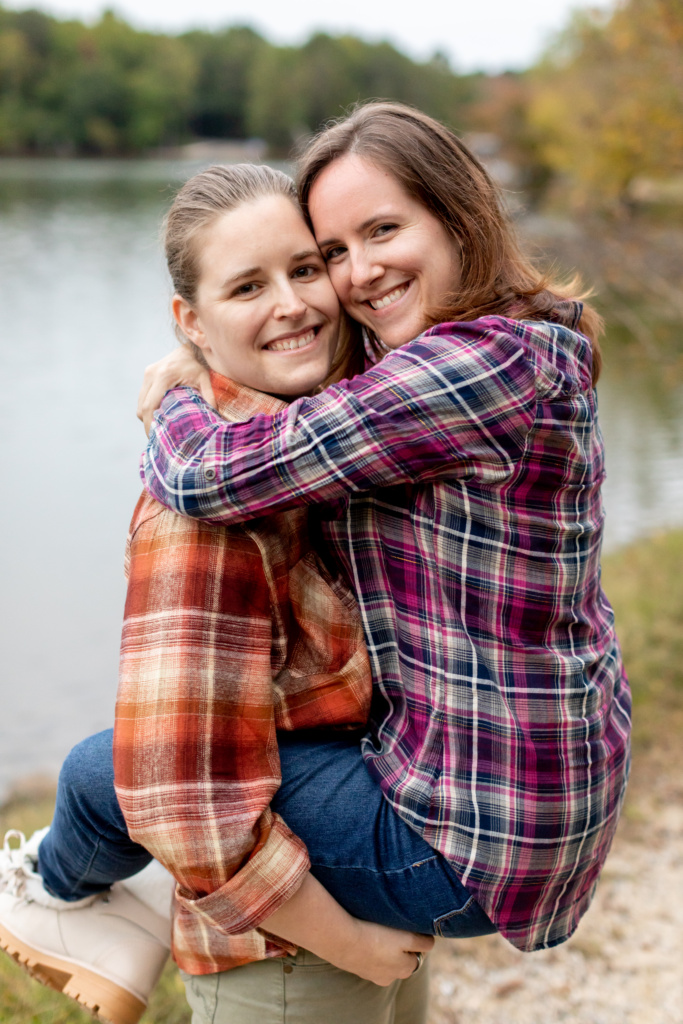 Woman holding another woman in arms for proposal