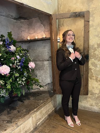 Woman smiling adjusting brown suit